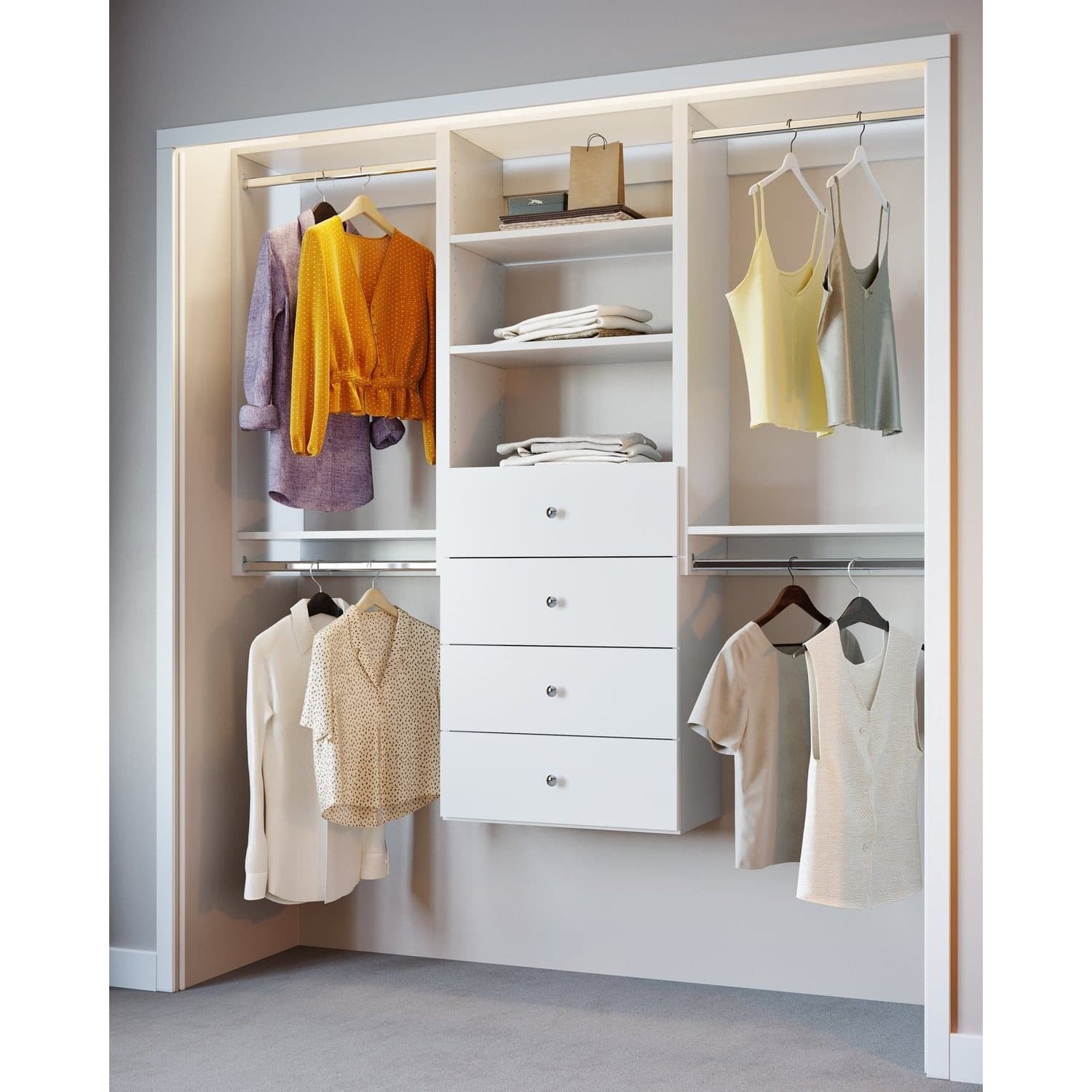 A white reach-in: double hanging on the left, a four-drawer bank in the middle under folded stacks, and a further hanging section on the right.
